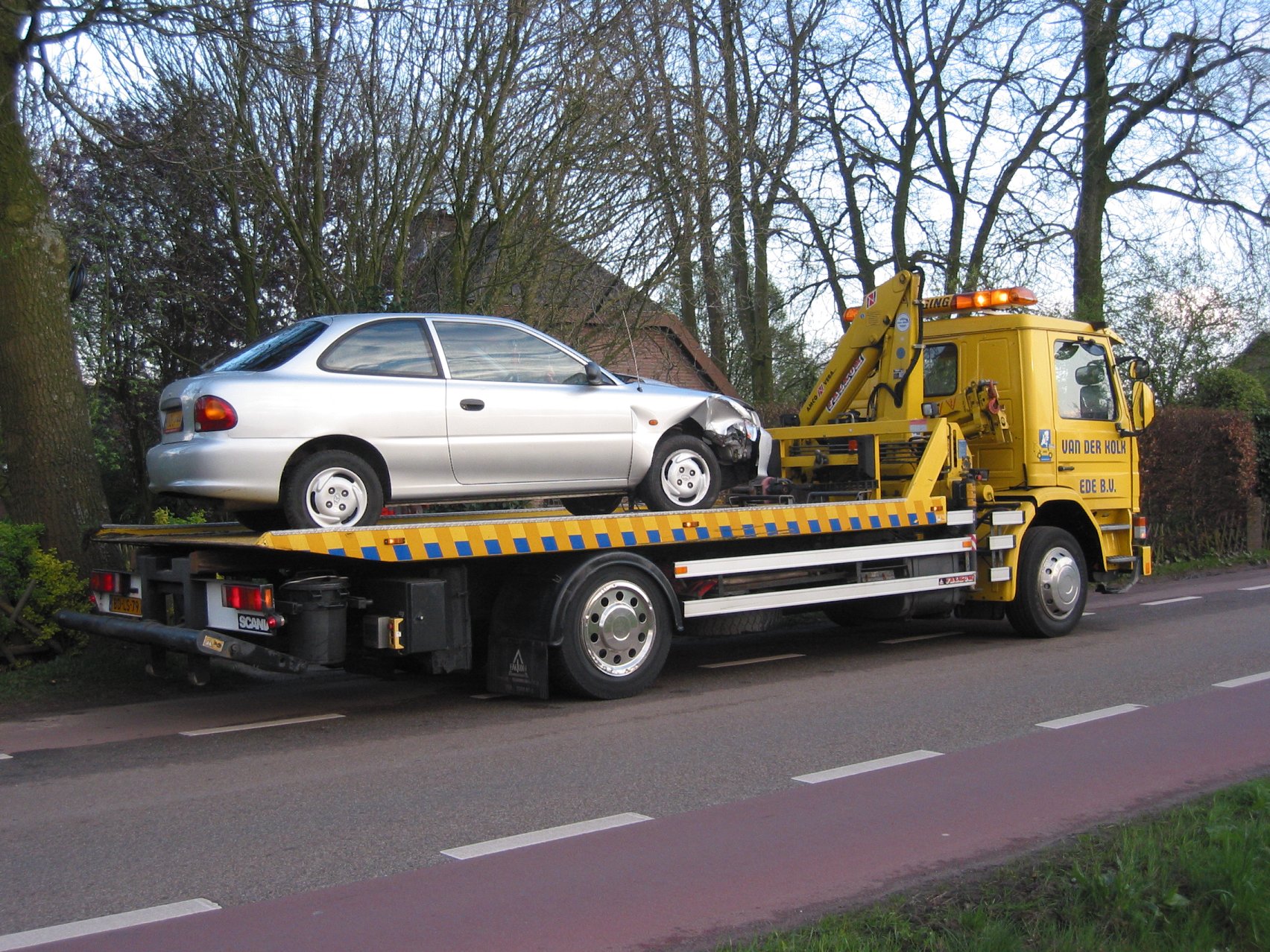Tralas su ant platformos pakrautu automobiliu